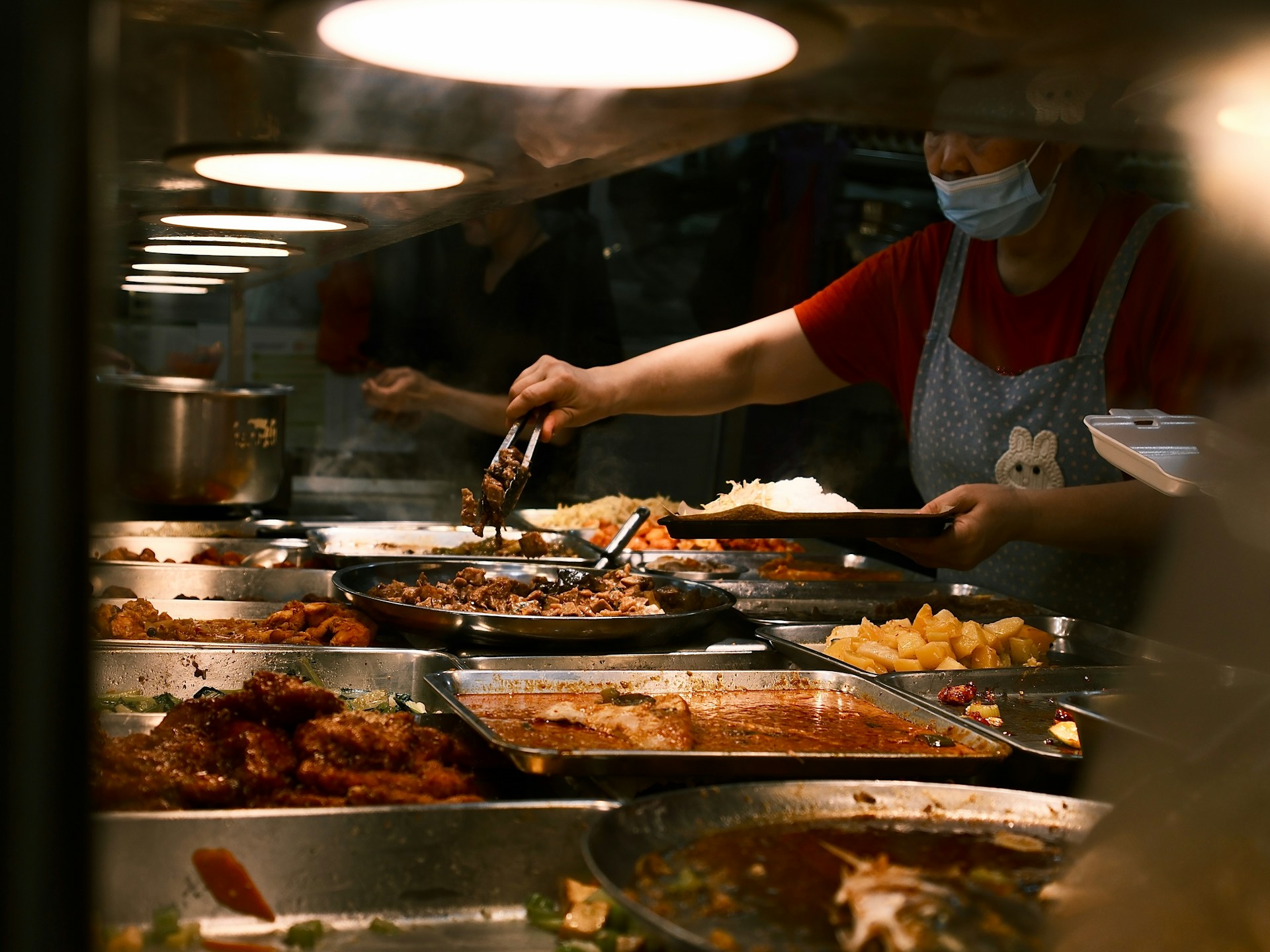 A Singapore hawker centre with food stalls and seated diners