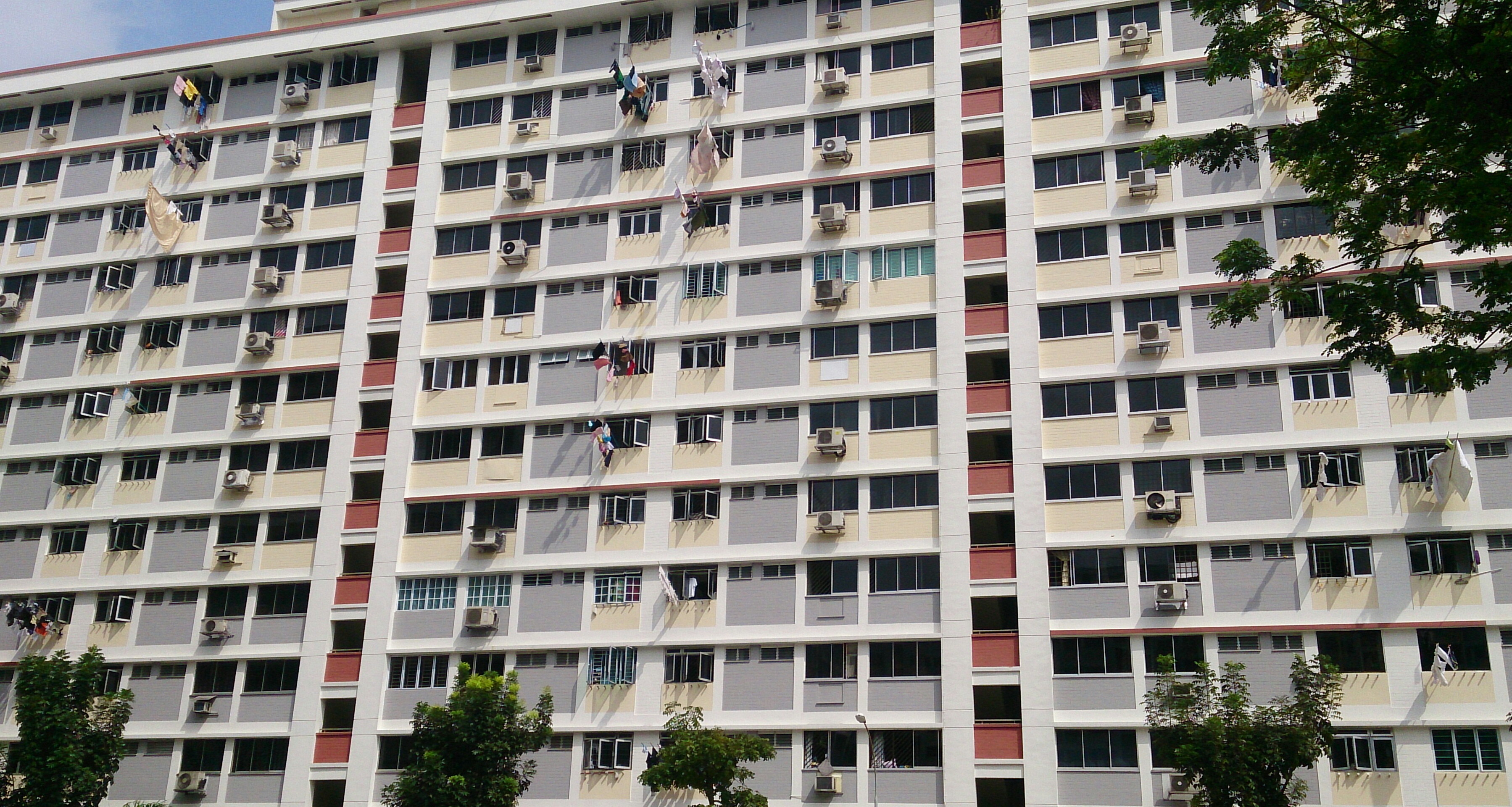 HDB blocks in Singapore with laundry hanging from windows — typical public-housing estates